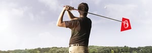 Ein Mann schlägt auf einem Golfplatz einen Ball mit dem Schläger – Symbol für Sport, Präzision und Networking – im Rahmen des DATAGROUP Golfturniers 2024.