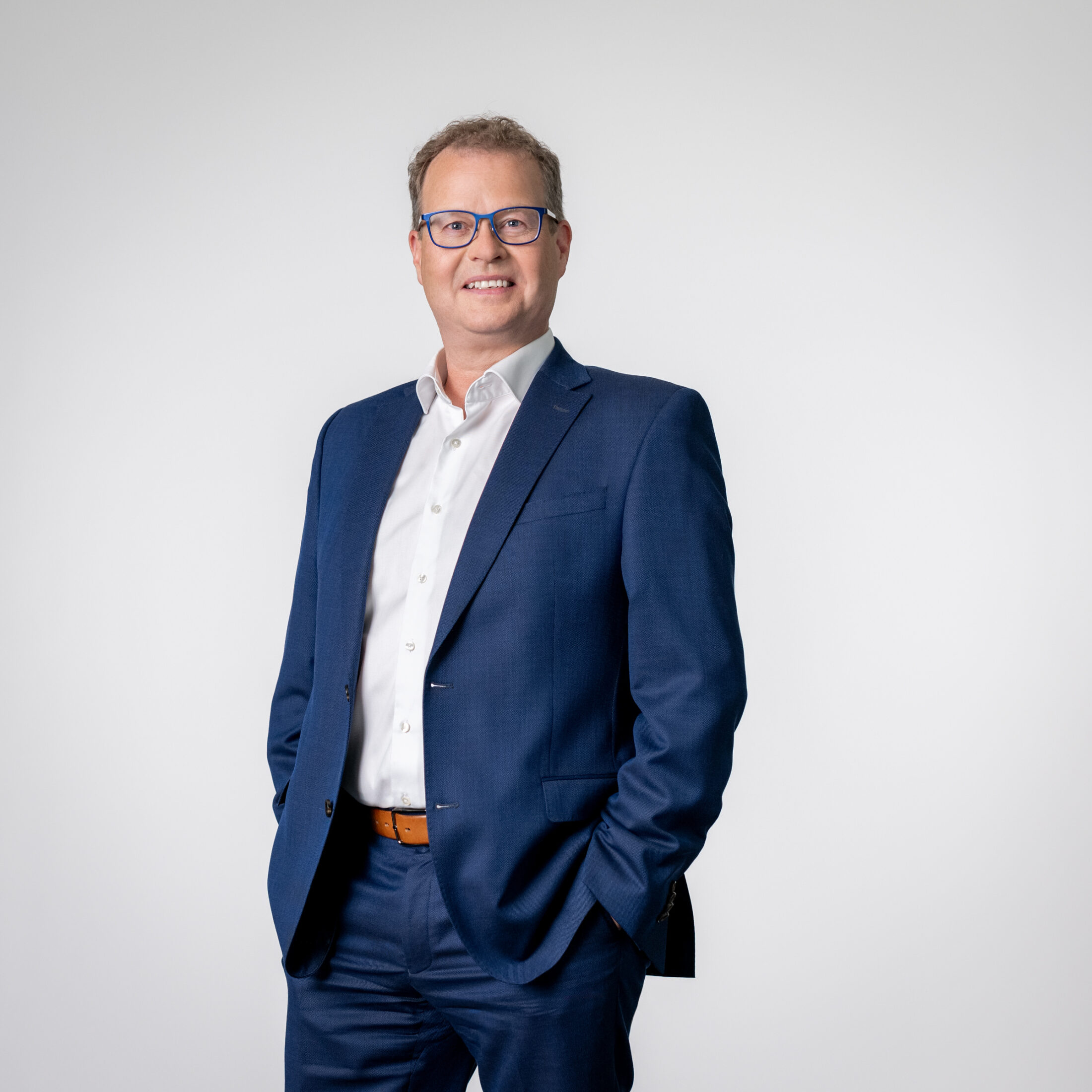 Photo of Mark Schäfer – Chief Production Officer at DATAGROUP – wearing a suit in front of a light gray background