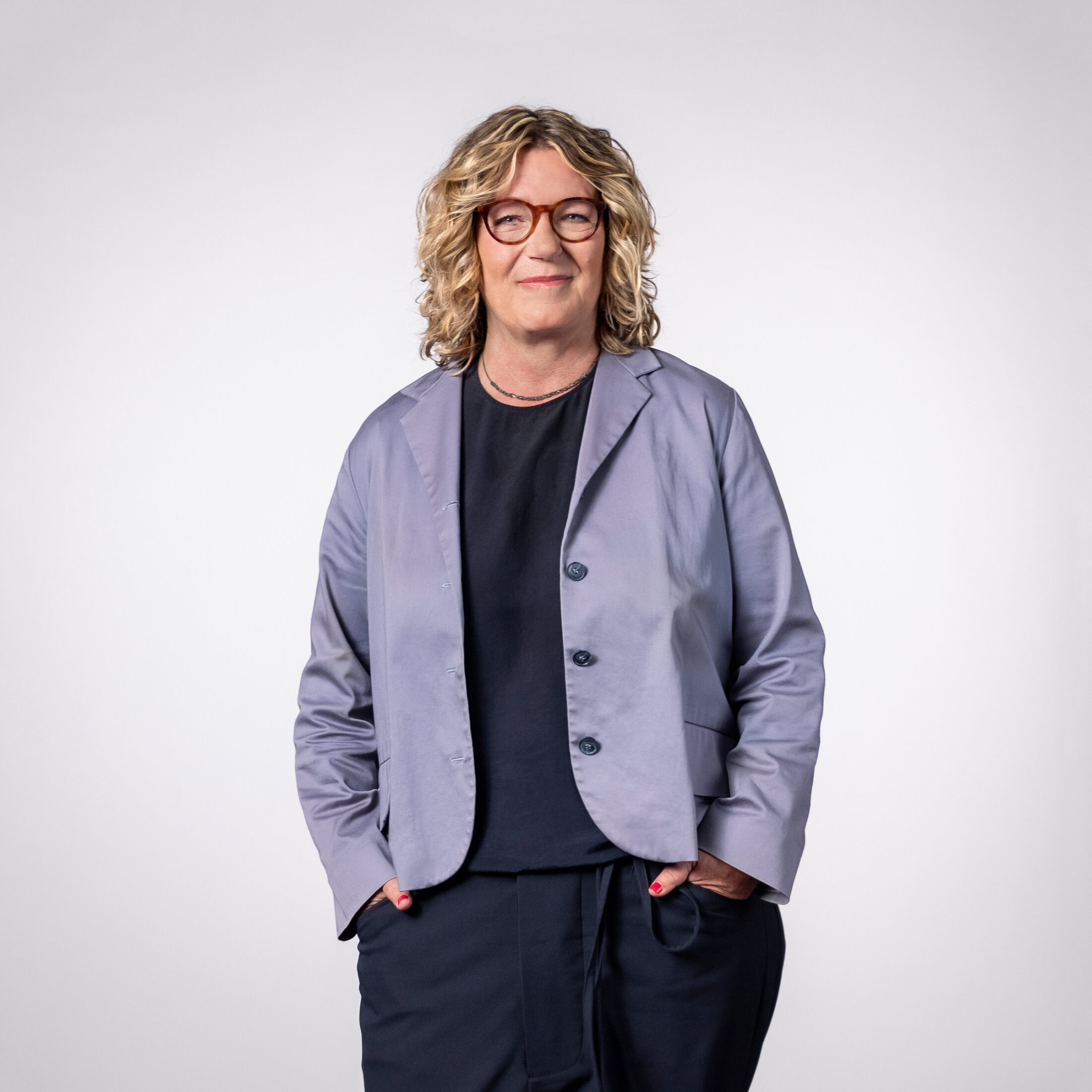 Photo of Alexandra Mülders, Head of Sales at DATAGROUP, wearing a suit in front of a light gray background
