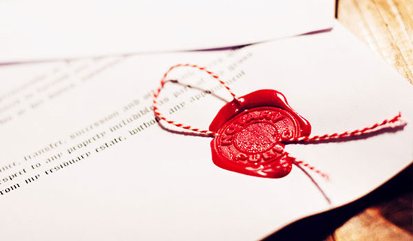 A document with a red wax seal and cord, symbolizing authenticity and binding validity.