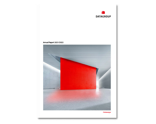 Cover page of the DATAGROUP Annual Report 2021/2022 featuring a modern architectural interior with a large red geometric wall panel in a minimalist gray space.