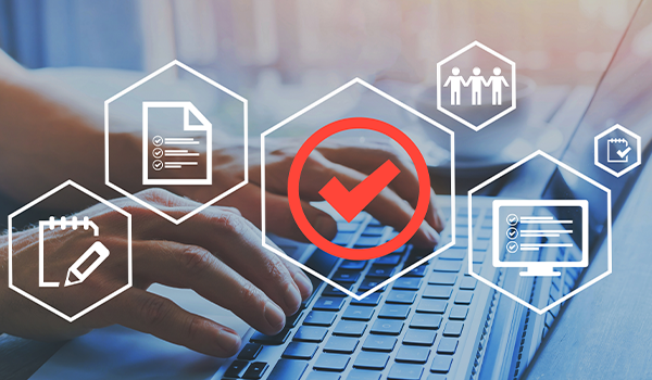 Hands typing on a laptop keyboard with digital icons and a red checkmark symbol overlayed, representing approval and digital processes.t