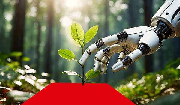 Roboterhand greift nach einer roten Fläche, auf der ein junger Baum wächst – Symbol für Nachhaltigkeit und Technologie