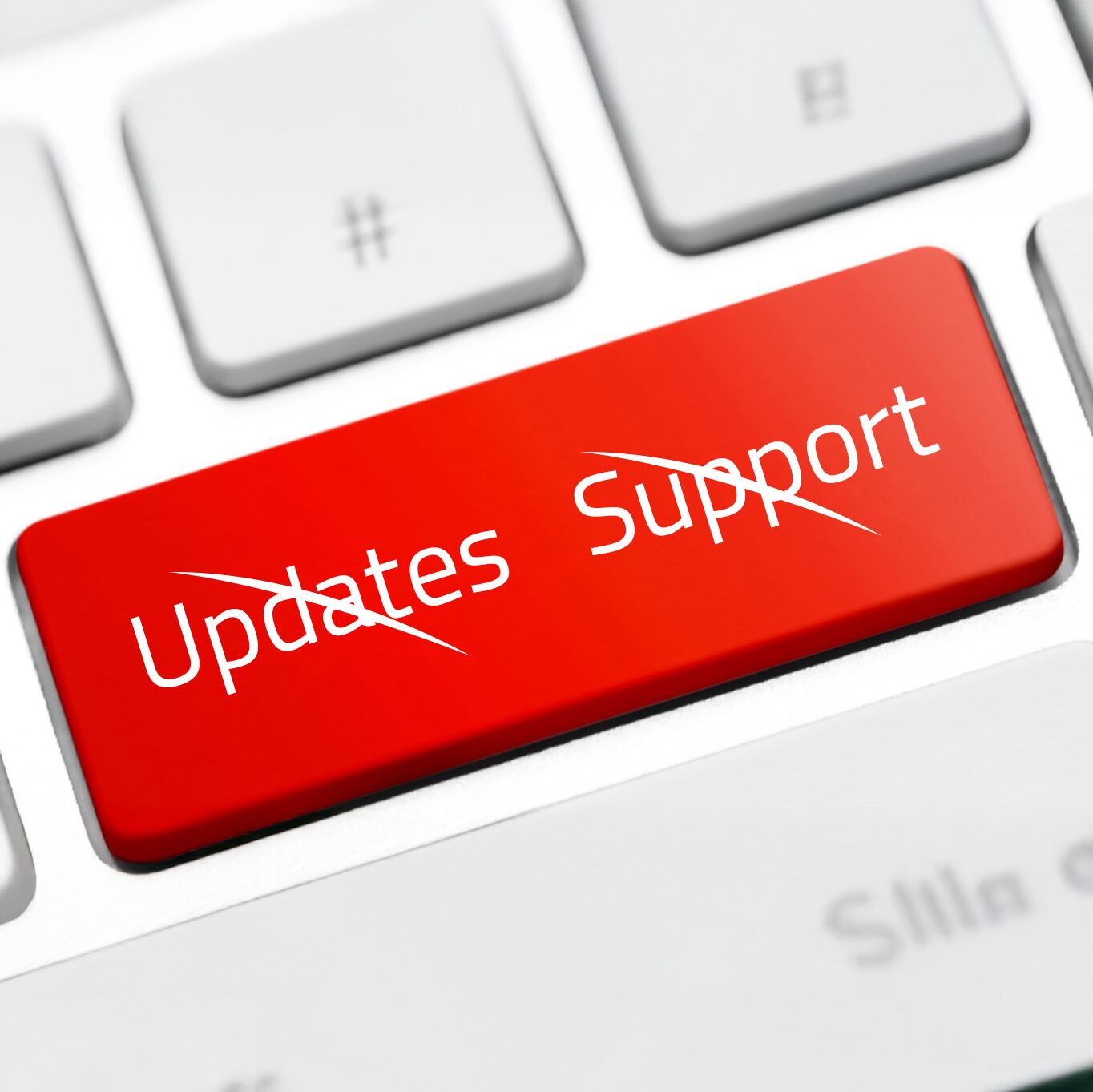 Rote Computertaste mit den durchgestrichenen Wörtern „Updates“ und „Support“ als Symbol für das Ende des Windows-10-Supports.